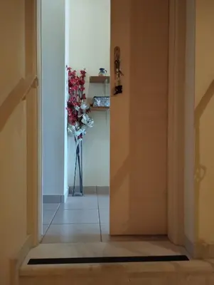 an open door with a vase of flowers in a hallway at Porta di Sabbia in Koum Kapi beach in Chania Town
