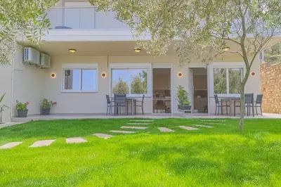 a house with a yard with green grass at Renovated apartment 2 -Platanias in Plataniás