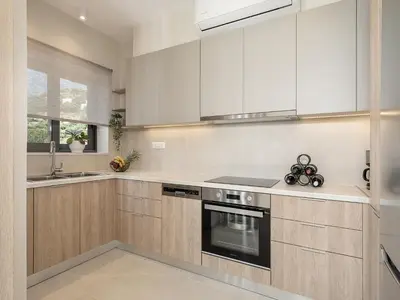 a kitchen with white cabinets and a stove top oven at GG Villas Falassarna in Chania Town