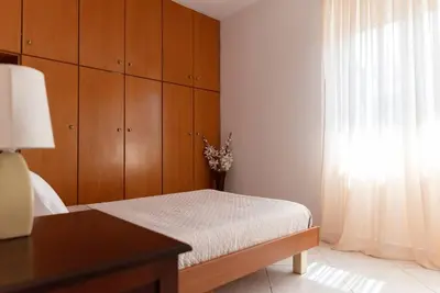 a bedroom with a bed and a window at Casa Valore central with parking by 8essentially in Chania Town