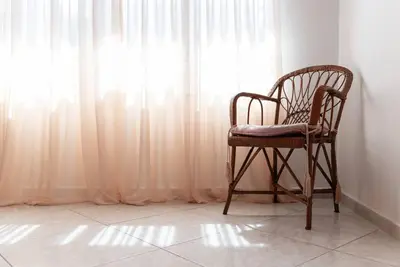 a chair sitting in front of a window at Casa Valore central with parking by 8essentially in Chania Town