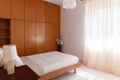 a bedroom with a bed and a dresser and a window at Casa Valore central with parking by 8essentially in Chania Town