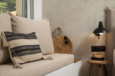 a couch with a pillow and a purse next to a window at Nomas lifestyle living in Chania Town
