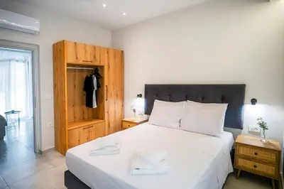a bedroom with a large white bed with white pillows at Sweven boutique apartments in Souda