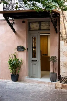 a front door of a house with two potted plants at Porto Vecchio in Chania Town