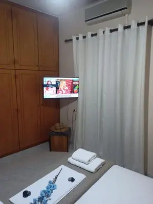 a room with a tv and a white curtain at Giannis House in Kissamos in Kissamos