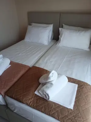 two beds with towels and pillows on them at Giannis House in Kissamos in Kissamos