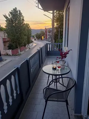 a table and chairs on a balcony with a street at Giannis House in Kissamos in Kissamos