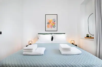 a bedroom with a blue bed with three pillows at Casa Verde Chania in Chania Town