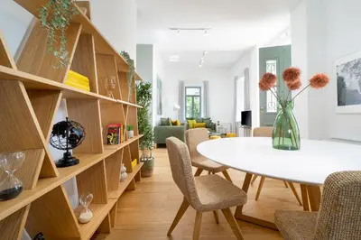 a dining room with a white table and chairs at Casa Verde Chania in Chania Town