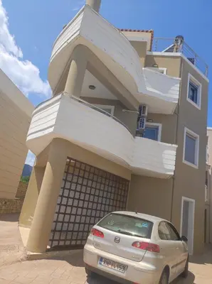 a car parked in front of a house at Christini Cozy Apartment in Souda