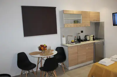 a small kitchen with a table and chairs and a counter at Angel's Nest in Chania Town