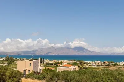 a view of a city with the ocean and mountains at Isabel Artemis Crete - Luxury Sea Views Villas in Nopíyia