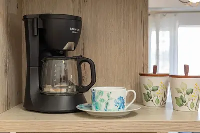 a coffee maker and coffee cups on a shelf at Koum Kapi Mare Studios B2 in Chania Town
