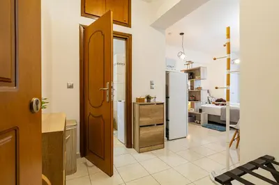 a kitchen with a refrigerator and a room with a bed at Koum Kapi Mare Studios B2 in Chania Town