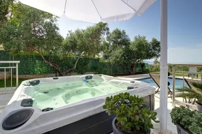 a jacuzzi tub on the patio of a house at Mabech Villa in Plataniás