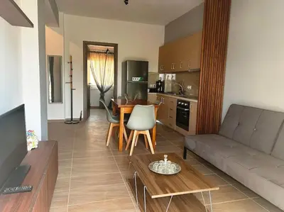 a living room with a couch and a table at Korina's Apartment in Daratso