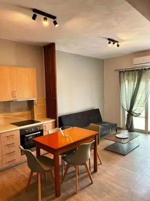 a kitchen and living room with a table and chairs at Korina's Apartment in Daratso