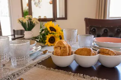 a table with bowls of food on a table at Garden Villa Chania in Chania Town
