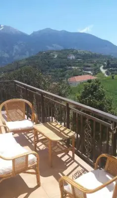a table and chairs on a balcony with a view at VILLA APHRODITE SOUGIA apt1 in Kamária