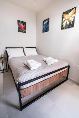 a bed in a room with two pillows on it at Callista City Living in Chania Town