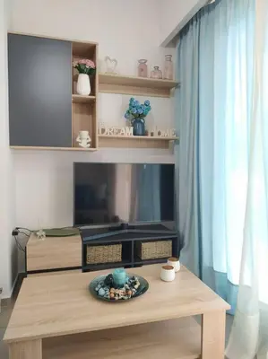a living room with a tv and a table at StelisIoanna in Chania Town
