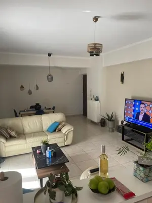 a living room with a couch and a tv at Tzitzifianaki apartment in Chania Town