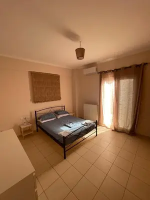 a bedroom with a bed and a window at Tzitzifianaki apartment in Chania Town