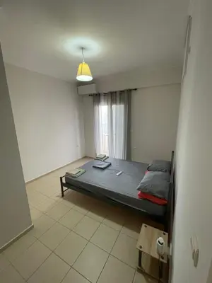 a bedroom with a bed and a window at Tzitzifianaki apartment in Chania Town