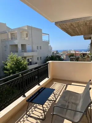 a balcony with a table and chairs on a balcony at Tzitzifianaki apartment in Chania Town