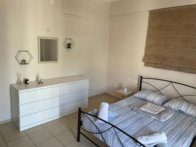 a bedroom with a bed and a sink at Tzitzifianaki apartment in Chania Town