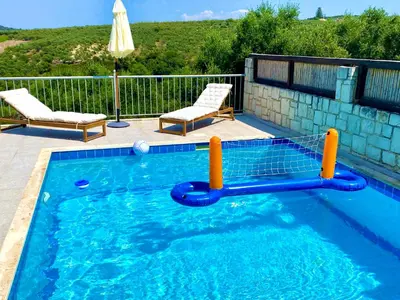 a small swimming pool with aogie board in the water at Villa Albama in Darmarochori