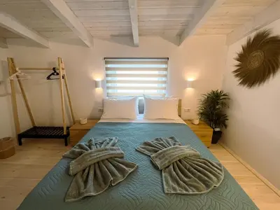 a bedroom with a bed with towels on it at Kerdos Home in Kalyves