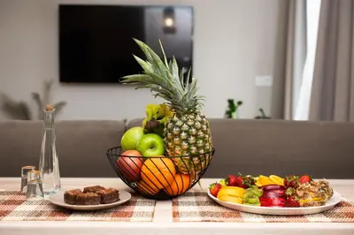 a table with two plates of fruit and a pineapple at Casa Moca in Chania Town