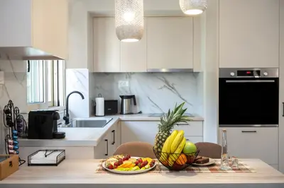 a kitchen with a table with a bowl of fruit on it at Casa Moca in Chania Town