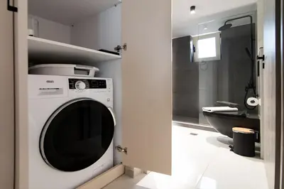 a washing machine in a bathroom with a toilet at Casa Moca in Chania Town