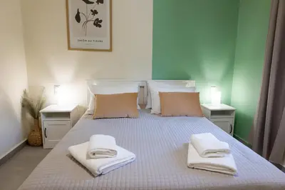 a bedroom with a bed with towels on it at Adriana Apartment in Agia Marina Nea Kydonias