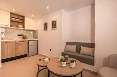 a living room with a couch and a table at Eva's apartments in Kissamos