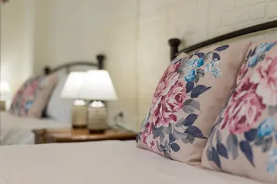 a bed with a pillow and a lamp on a table at Helios studio next to the sea BY APOKORONAS-VILLAS in Kalyves
