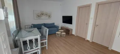 a living room with a blue couch and a table at Aeropis Villa, Chania in Chania Town