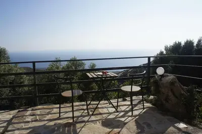a table and chairs on top of a rock at Alegria stone house in AmigdhalokeFálion