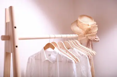 a woman wearing a hat and a white dress on a rack at Kabanas 2 luxury Suite in Chania Town
