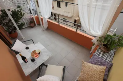 a view of a balcony with a table with a pizza at Kabanas 2 luxury Suite in Chania Town