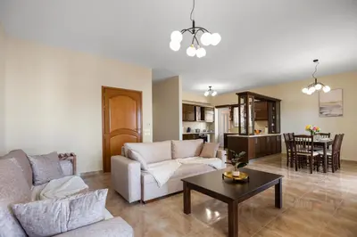 a living room with a couch and a table at Patelakis Apartment near the Beach in Chania Town