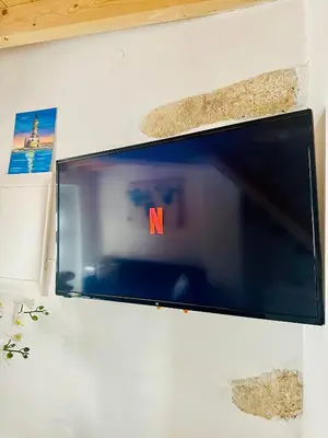 a flat screen tv hanging on a wall at Julia's cottage in Kalyves