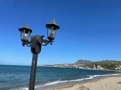 a street light on the beach next to the ocean at Julia's cottage in Kalyves