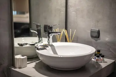 a bathroom with a sink and a mirror at Black Suites in Chania Town