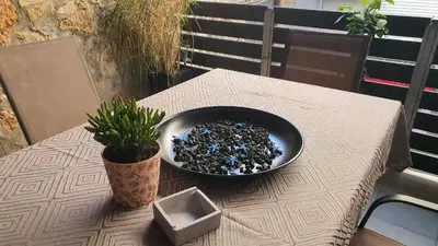 a bowl of rocks sitting on a table with a plant at Black Suites in Chania Town