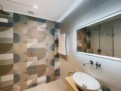 a bathroom with a sink and a mirror at Urban Hive Chania, Your City Basecamp - Fiber Wifi in Chania Town