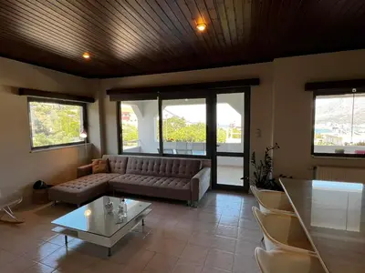 a living room with a couch and a table at blue and green II in Chania Town